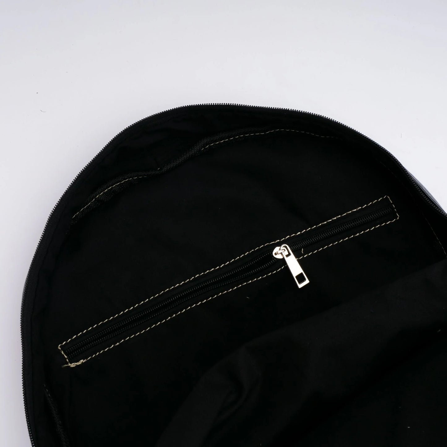 Close-up of a black bag with a zipper on a white background