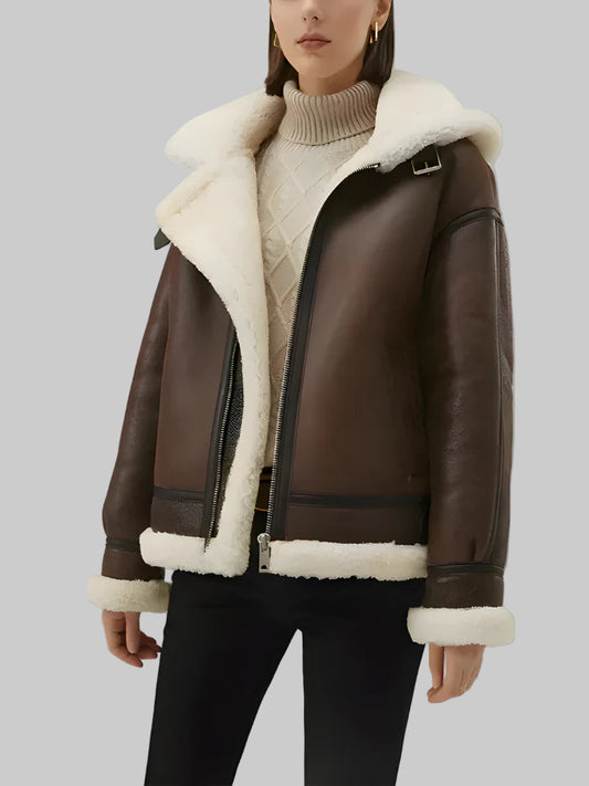 Brown leather jacket with white fur lining worn by a person on a light gray background