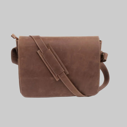 A brown leather messenger bag with a wide adjustable shoulder strap, displayed against a clean white background.