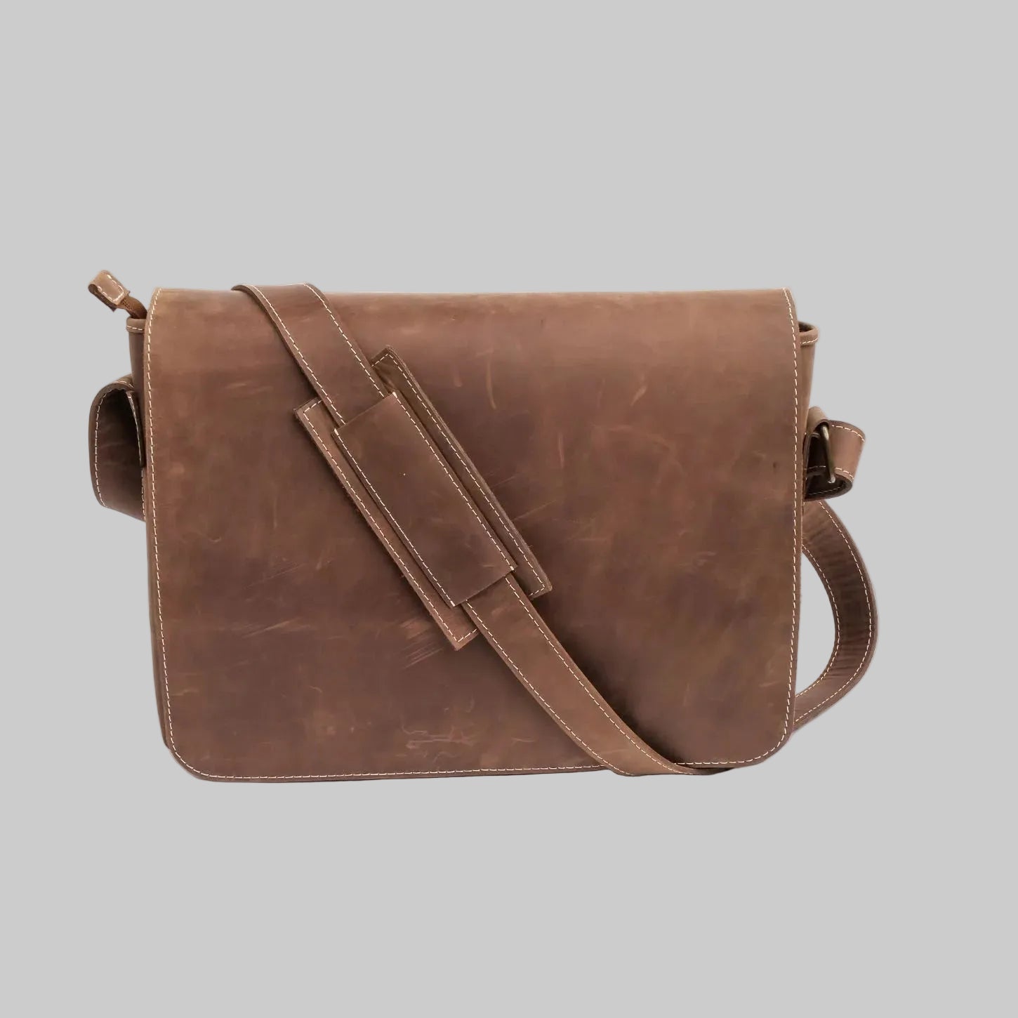 Brown leather messenger bag on a white background