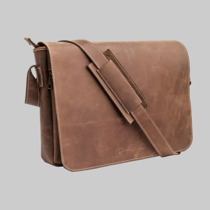 A brown distressed leather messenger bag with a wide adjustable shoulder strap and a zippered side pocket, shown on a plain white background.