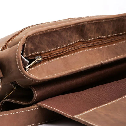 Close-up of a brown leather bag with zippers