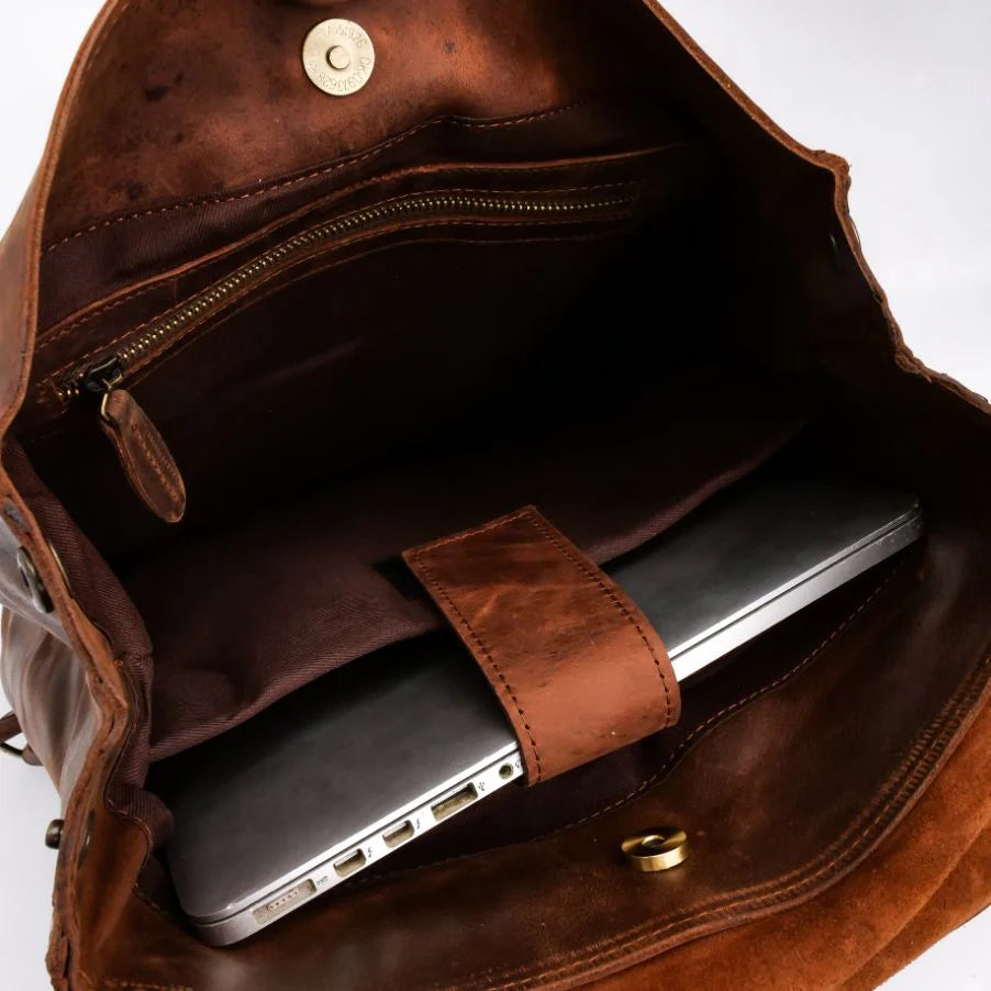 Brown leather bag with a laptop inside on a white background