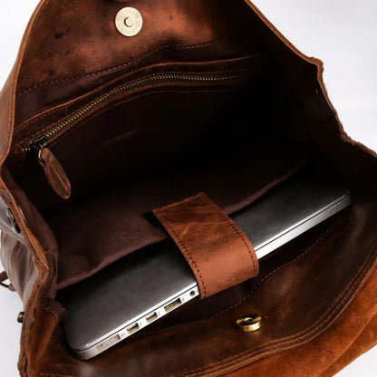 Brown leather bag with a laptop inside on a white background