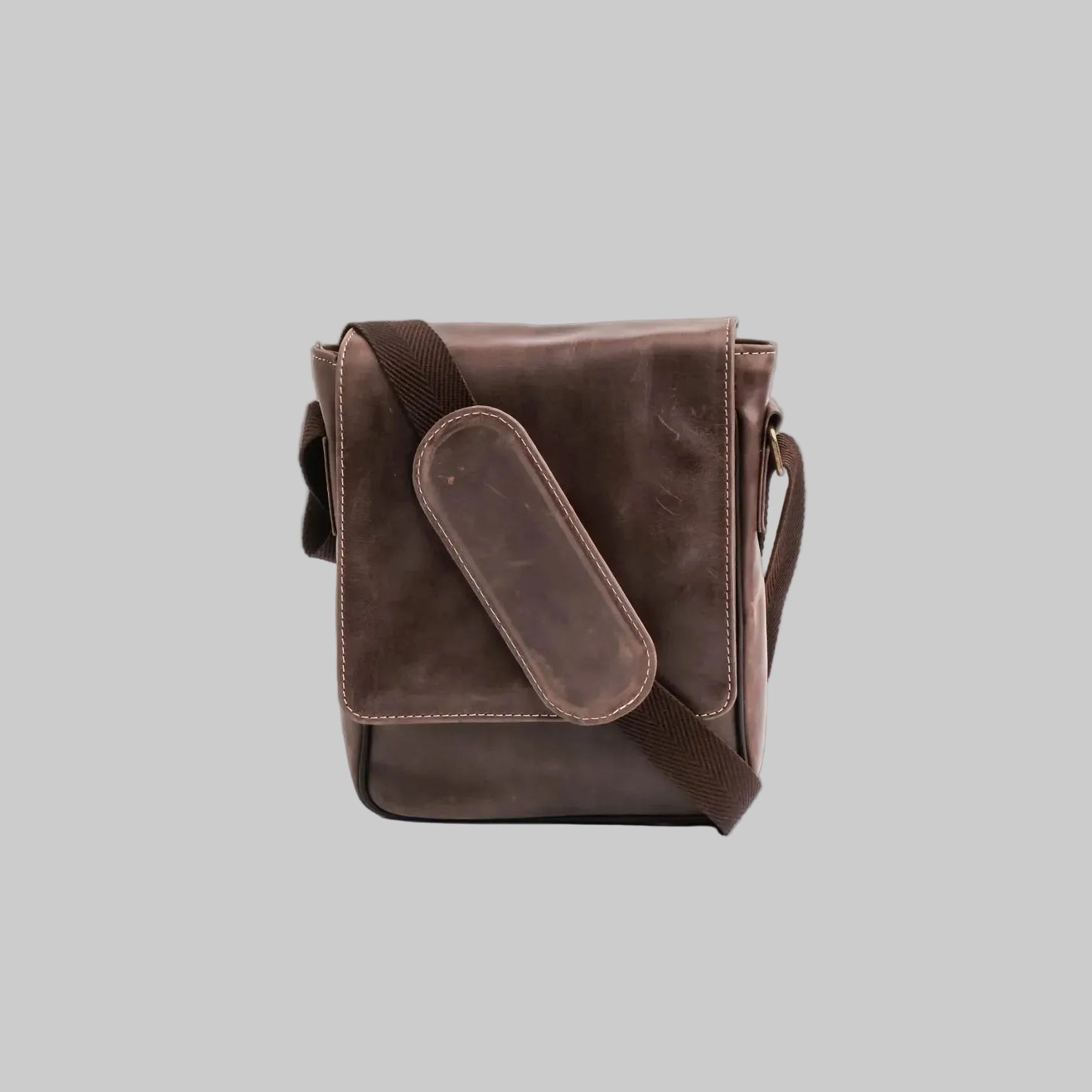 Brown leather crossbody bag on a white background