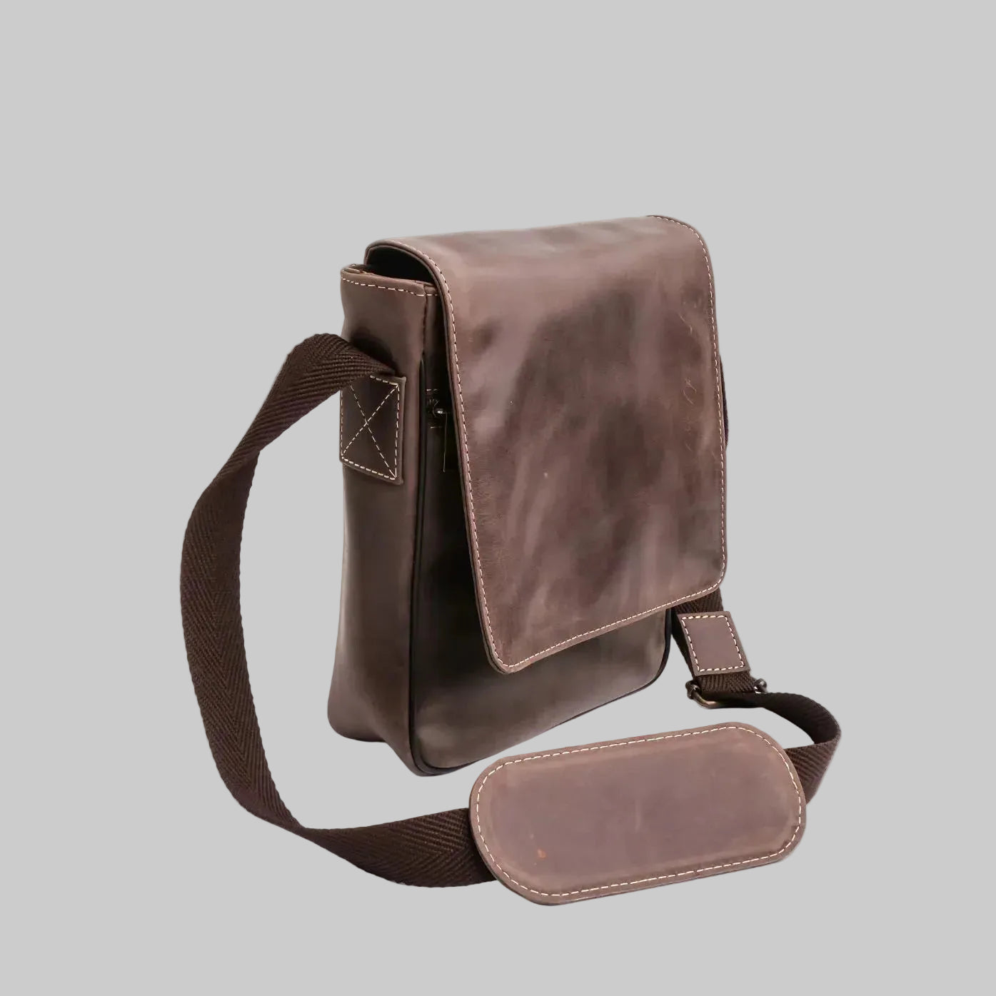Brown leather crossbody bag on a white background