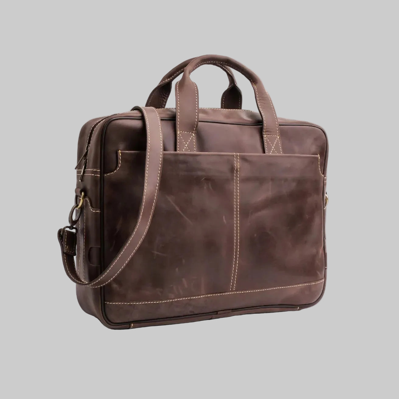Brown leather briefcase with shoulder strap on a white background