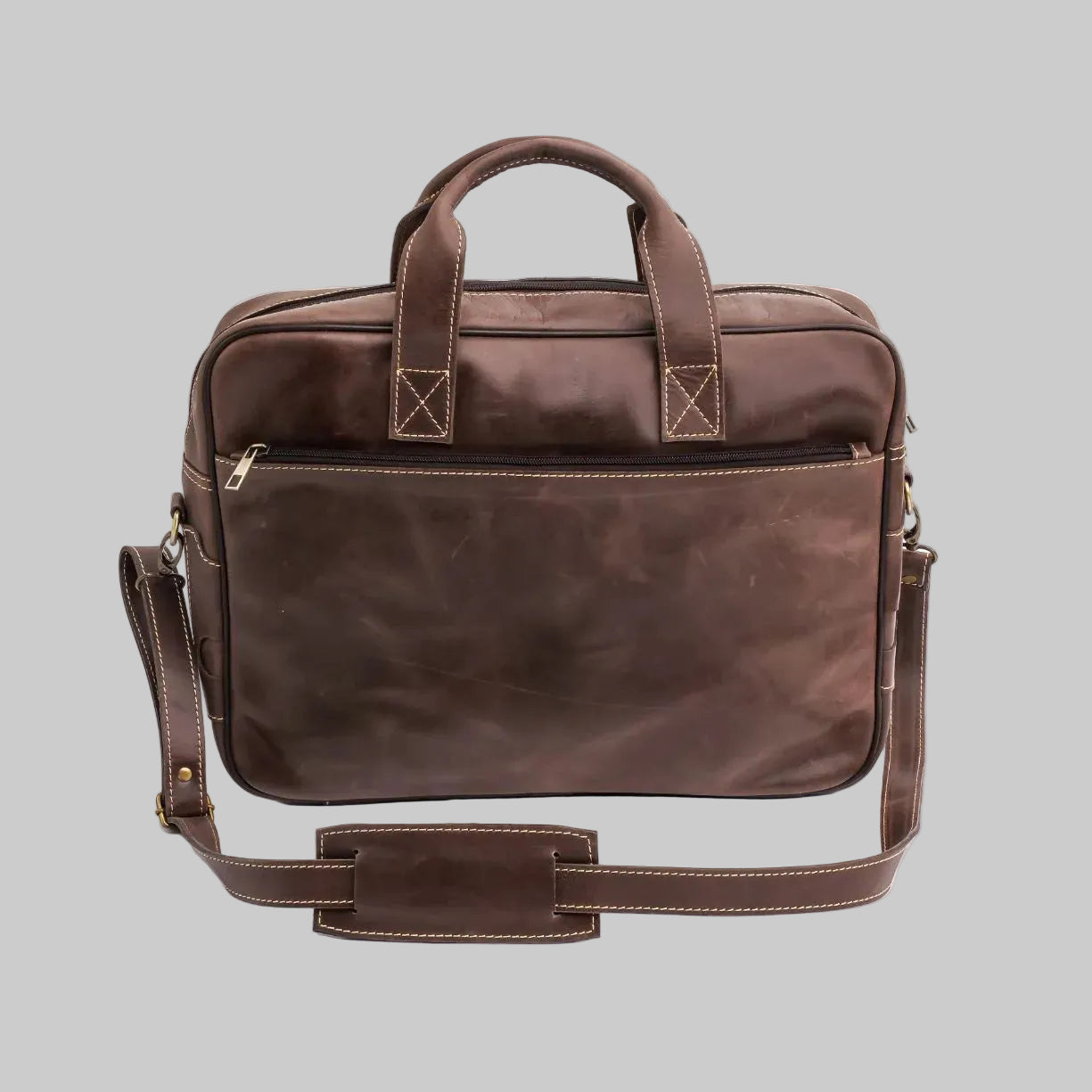Brown leather briefcase with shoulder strap on a white background