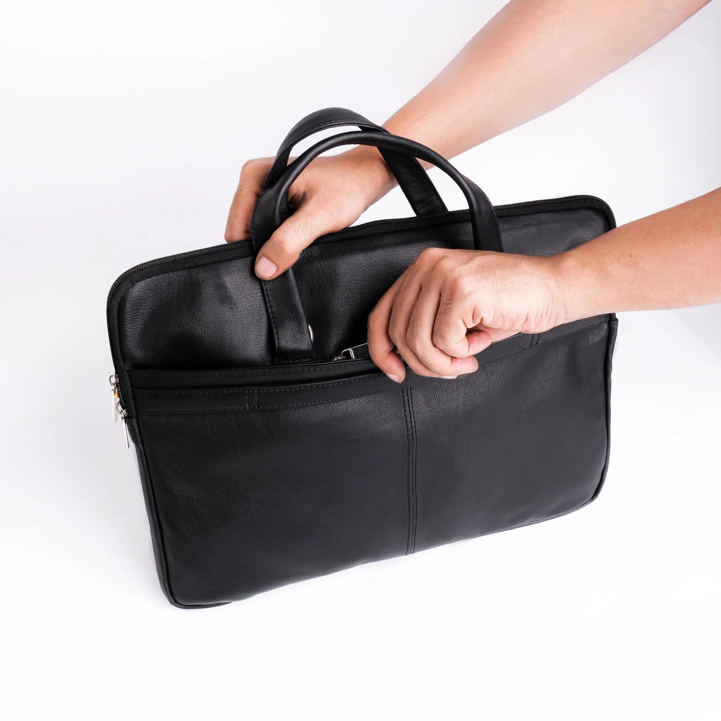 Black leather briefcase held by a person on a white background