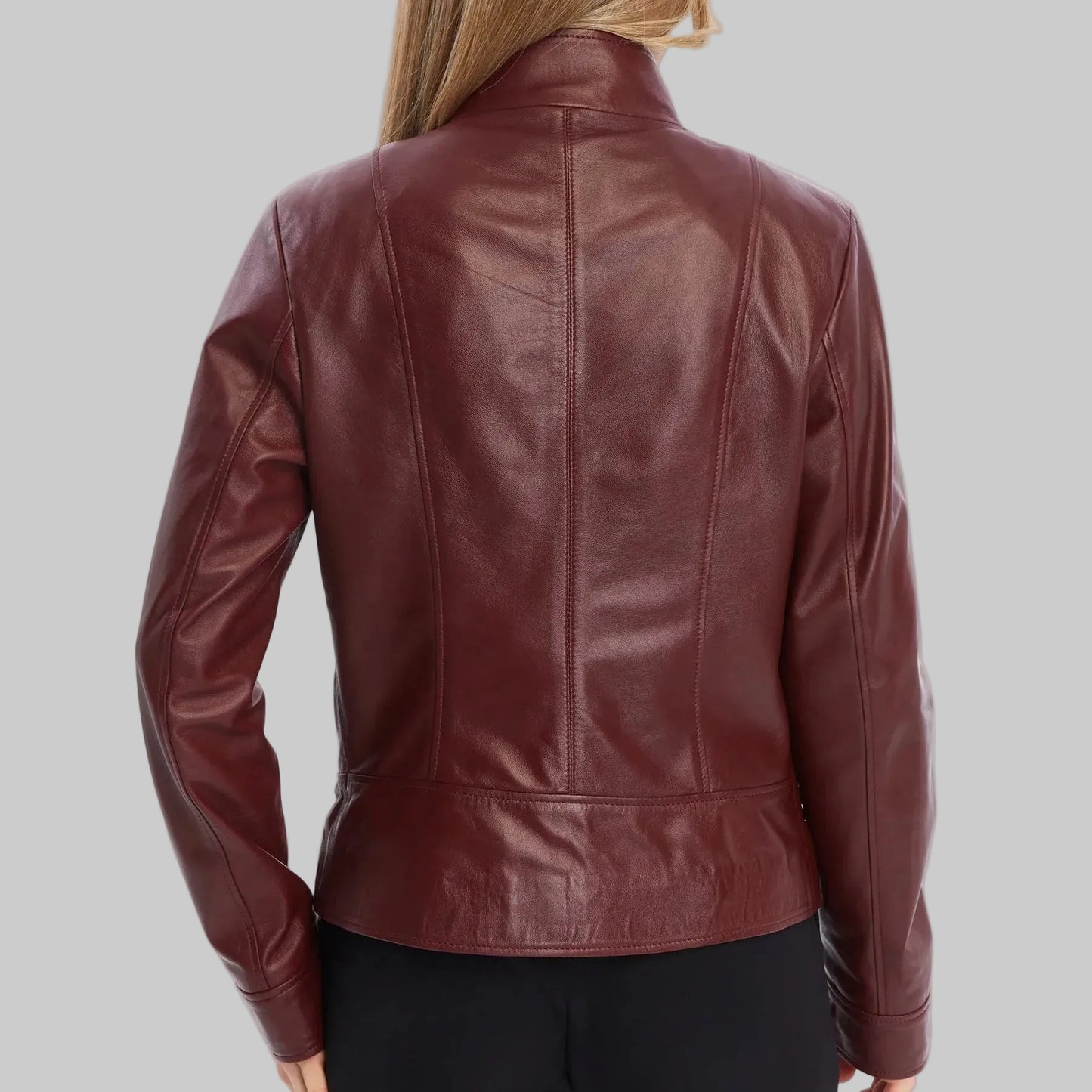 Woman wearing a burgundy leather jacket on a white background
