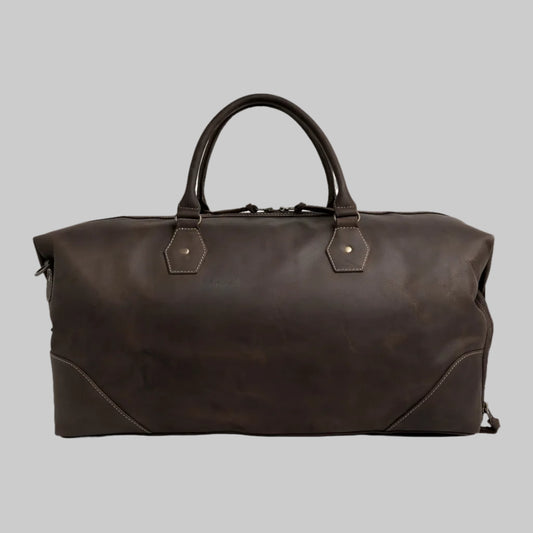 Brown leather duffel bag on a white background