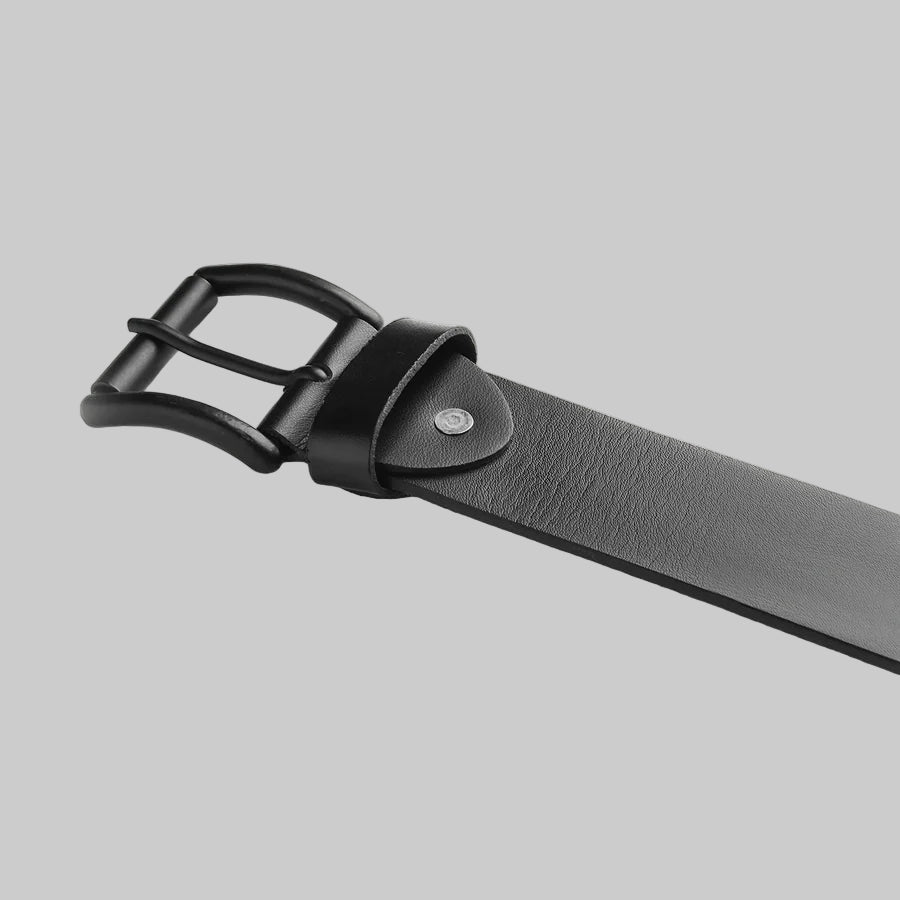 Black leather belt with a buckle on a light gray background