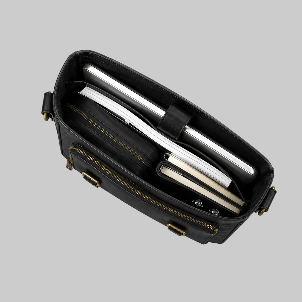 Black leather briefcase with silver interior and gold accents on a white background