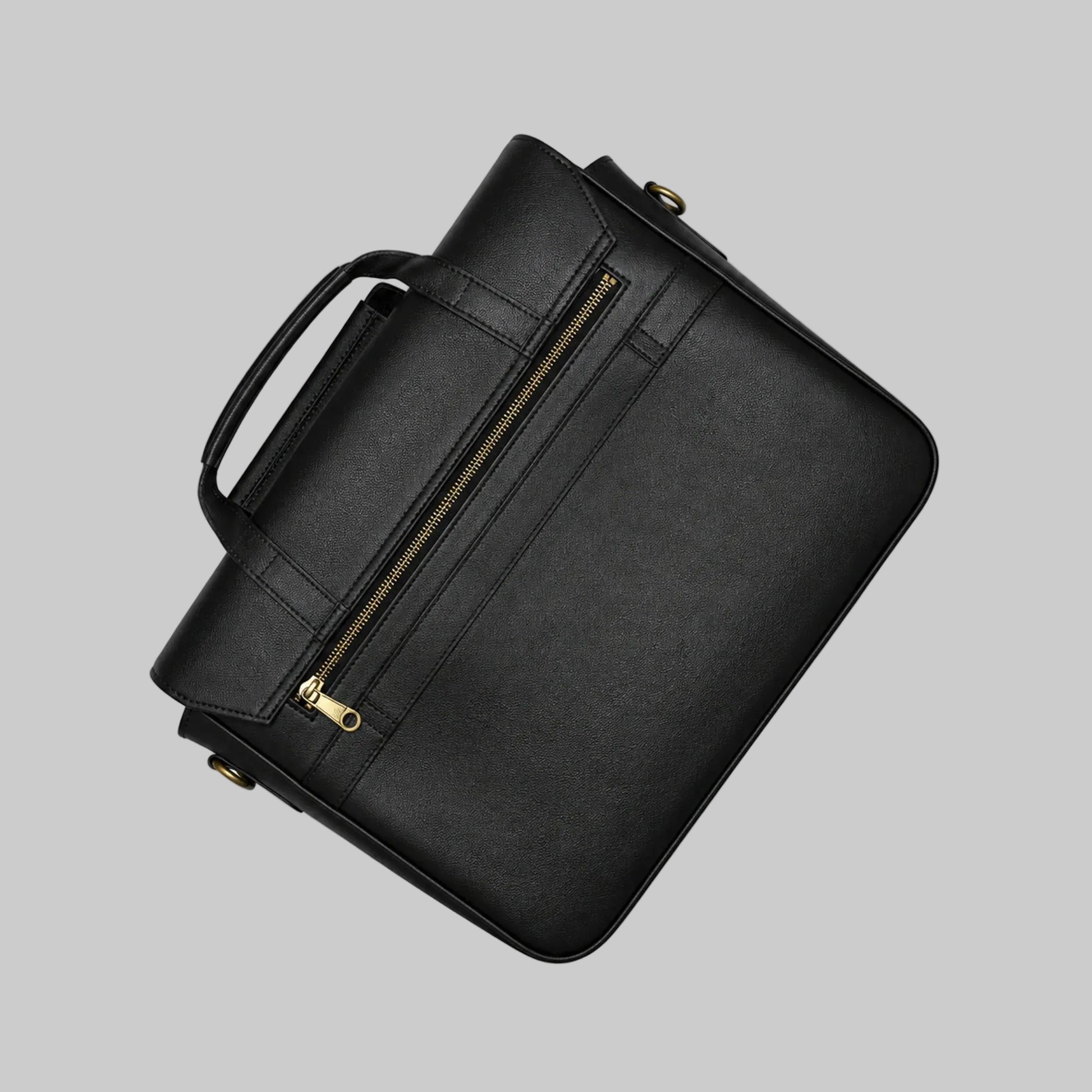 Black leather briefcase with gold zipper on a white background