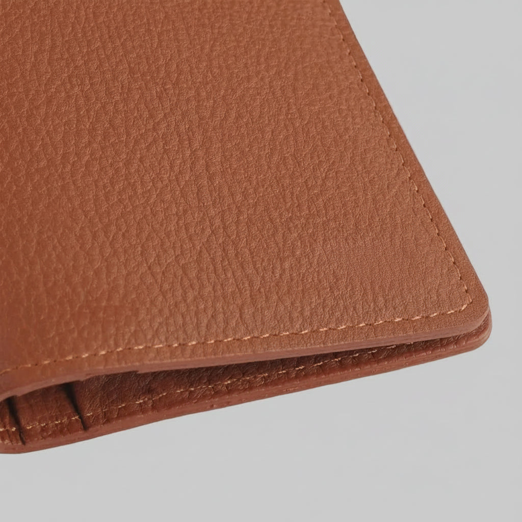 Close-up of a brown leather wallet on a light gray background