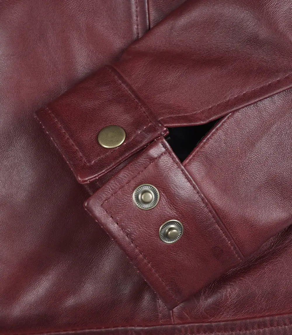 Close-up of a maroon leather jacket with buttons