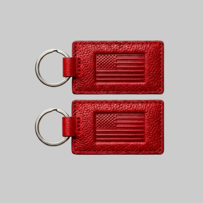 Two red leather keychains with American flag design on a white background