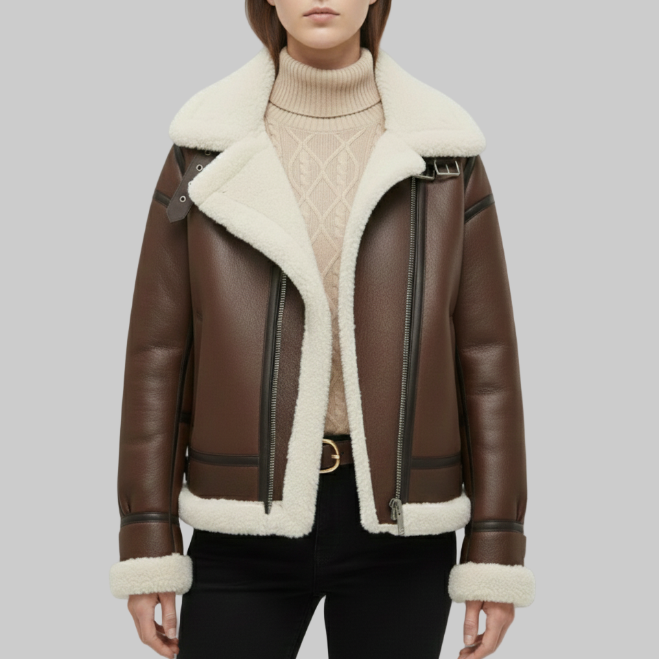 Brown leather jacket with white fur lining worn by a person on a gray background