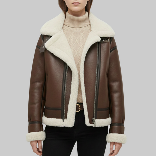 Brown leather jacket with white fur lining worn by a person on a gray background