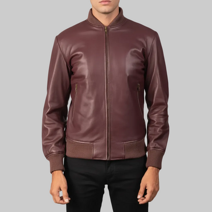Burgundy leather bomber jacket worn by a person on a white background