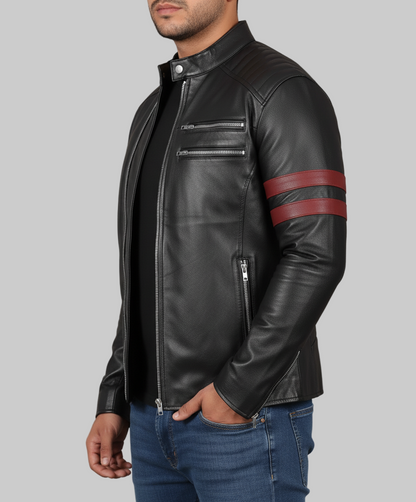 Black leather jacket with red stripes on sleeves worn by a person against a gray background