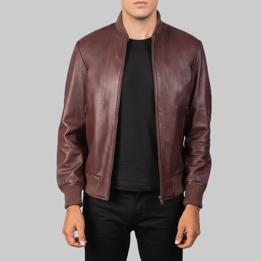 Burgundy leather bomber jacket worn by a person on a white background