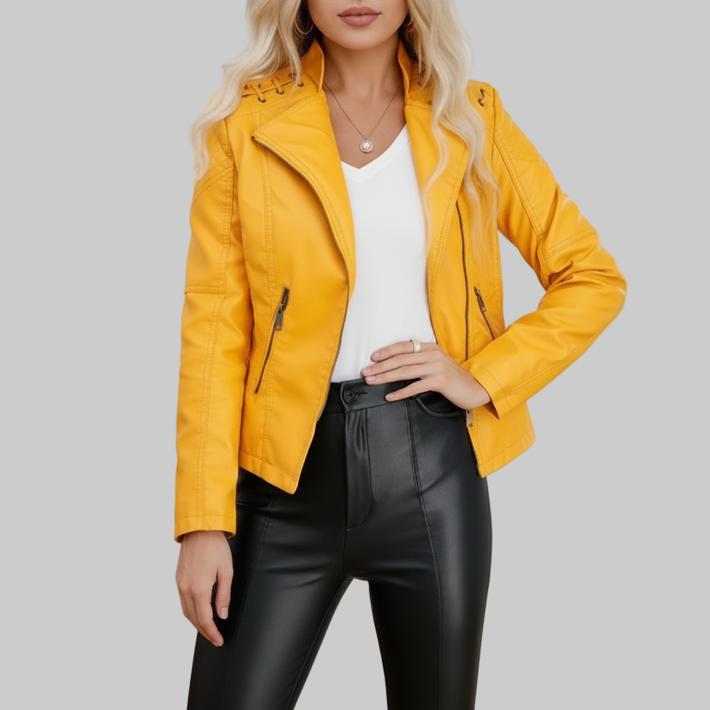 Woman wearing a yellow jacket, white top, and black pants in an indoor setting.