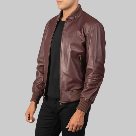 Burgundy leather bomber jacket worn by a person on a white background