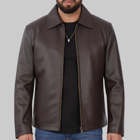 Man wearing a brown leather jacket over a black shirt and blue jeans on a white background