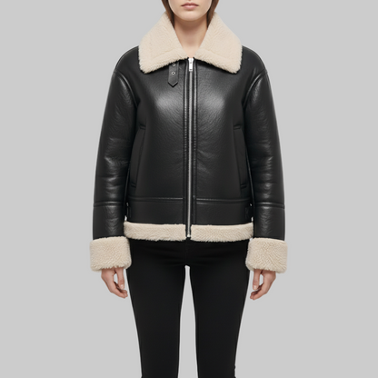 Black leather jacket with beige shearling collar and cuffs on a white background