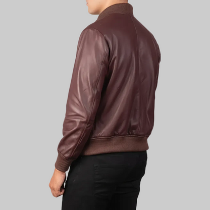 Burgundy leather bomber jacket worn by a person on a white background