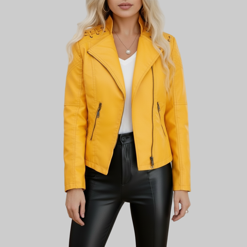 Woman wearing a yellow leather jacket with a white top and black pants in an indoor setting.