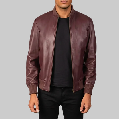 Burgundy leather bomber jacket worn by a person on a white background