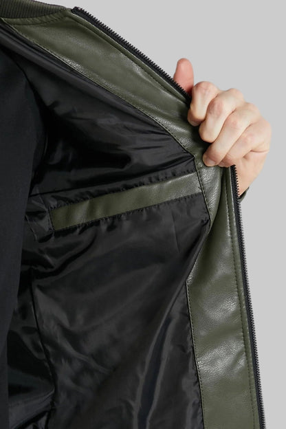 Close-up of a person opening a black jacket with a zipper on a light gray background