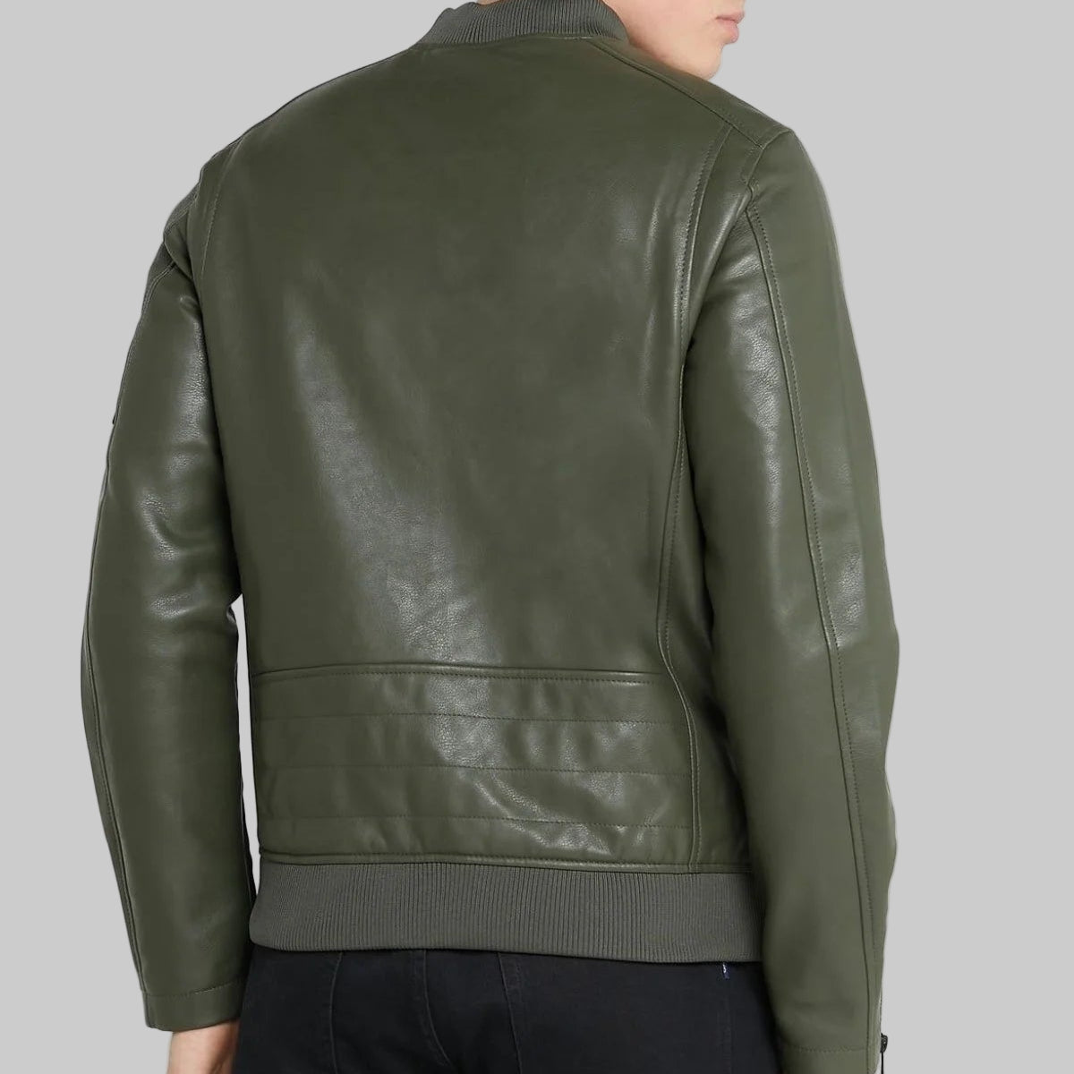 Person wearing a green leather jacket on a white background