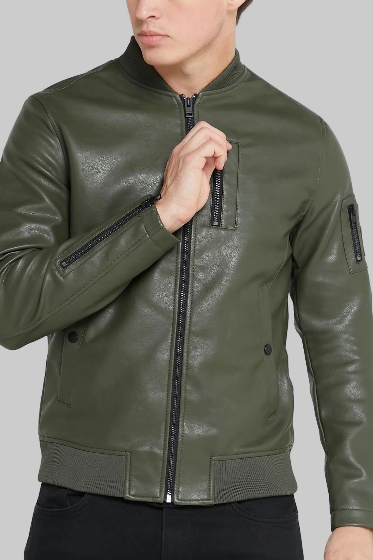 Green leather jacket worn by a person on a white background