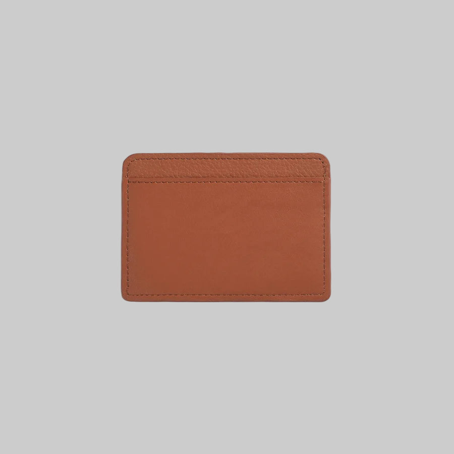 Brown leather cardholder on a light gray background