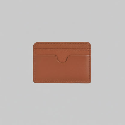 Brown leather cardholder with 'TRUCARRY' branding on a light gray background