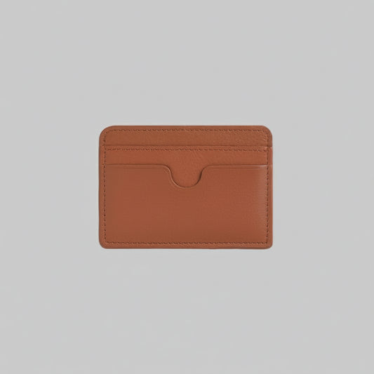 Brown leather cardholder with 'TRUCARRY' branding on a light gray background