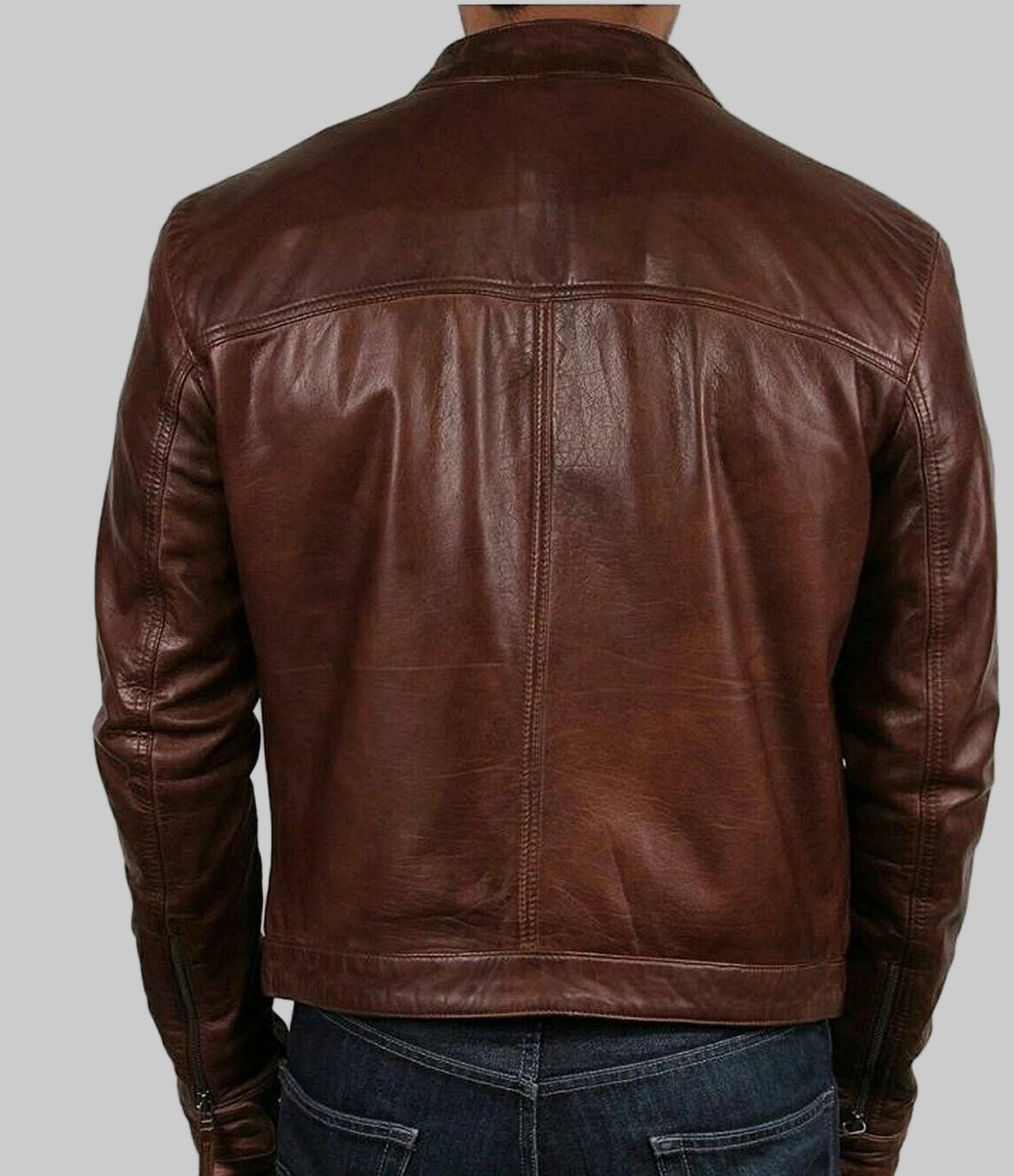 Brown leather jacket worn by a person on a white background