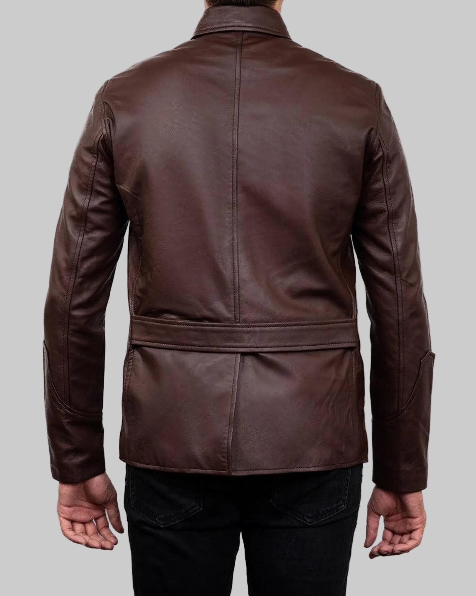 Brown leather jacket worn by a person on a white background