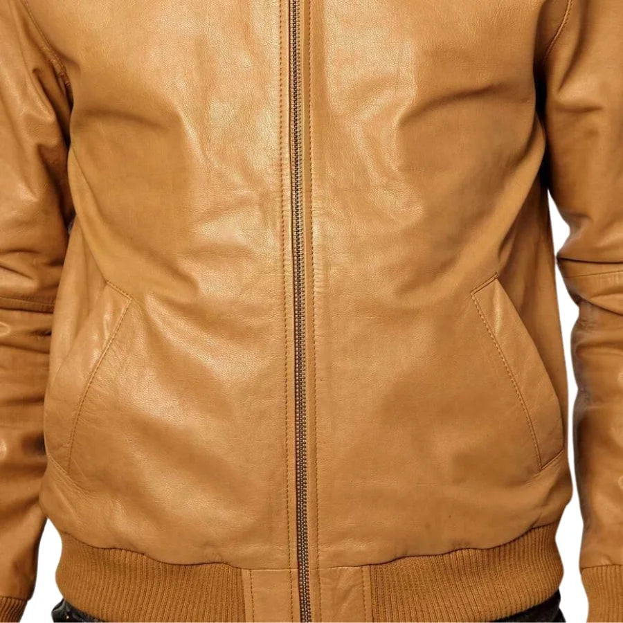 Close-up of a tan leather jacket with a zipper on a white background