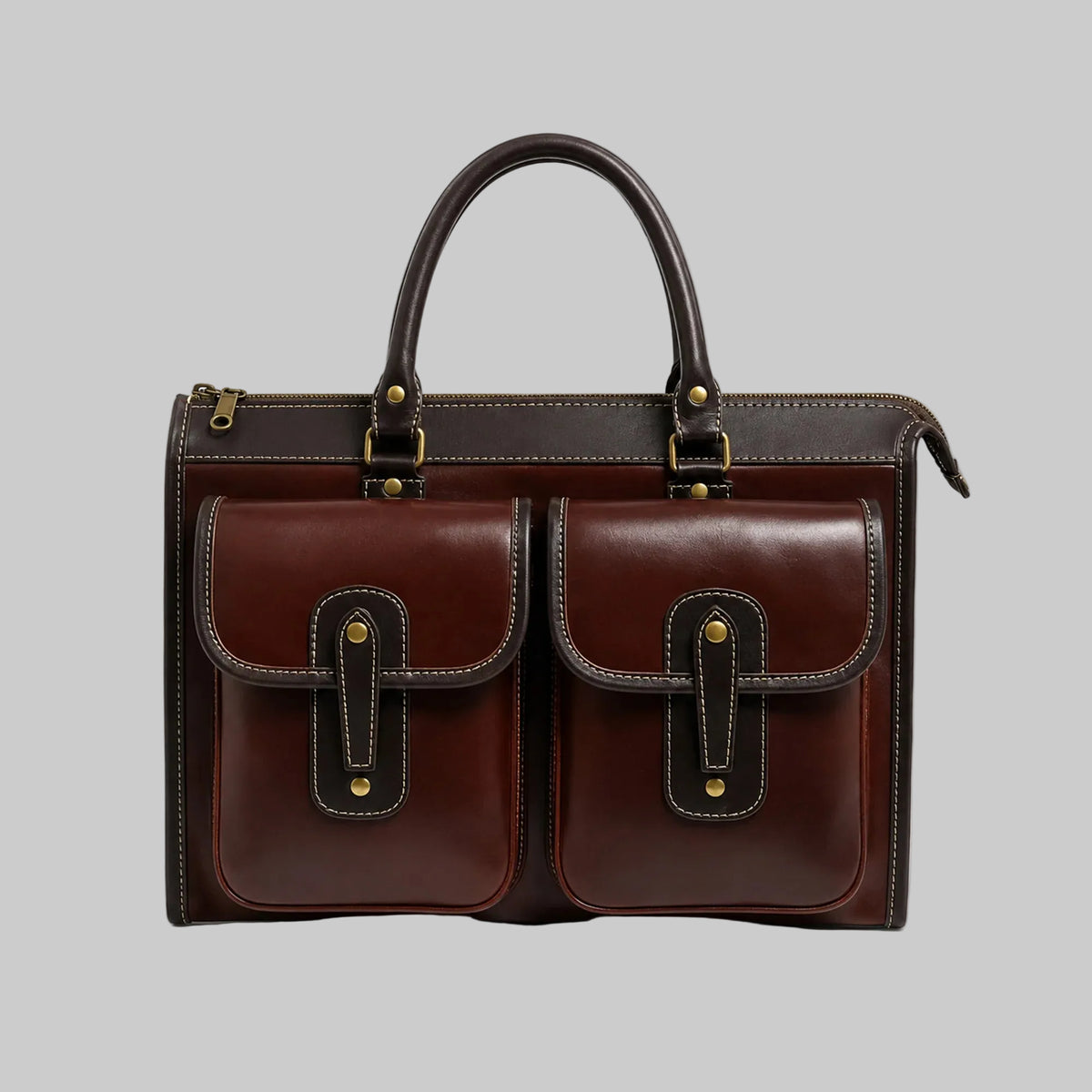 A dark brown leather briefcase with two front flap pockets, gold-tone hardware, and a top handle, photographed on a clean white background.