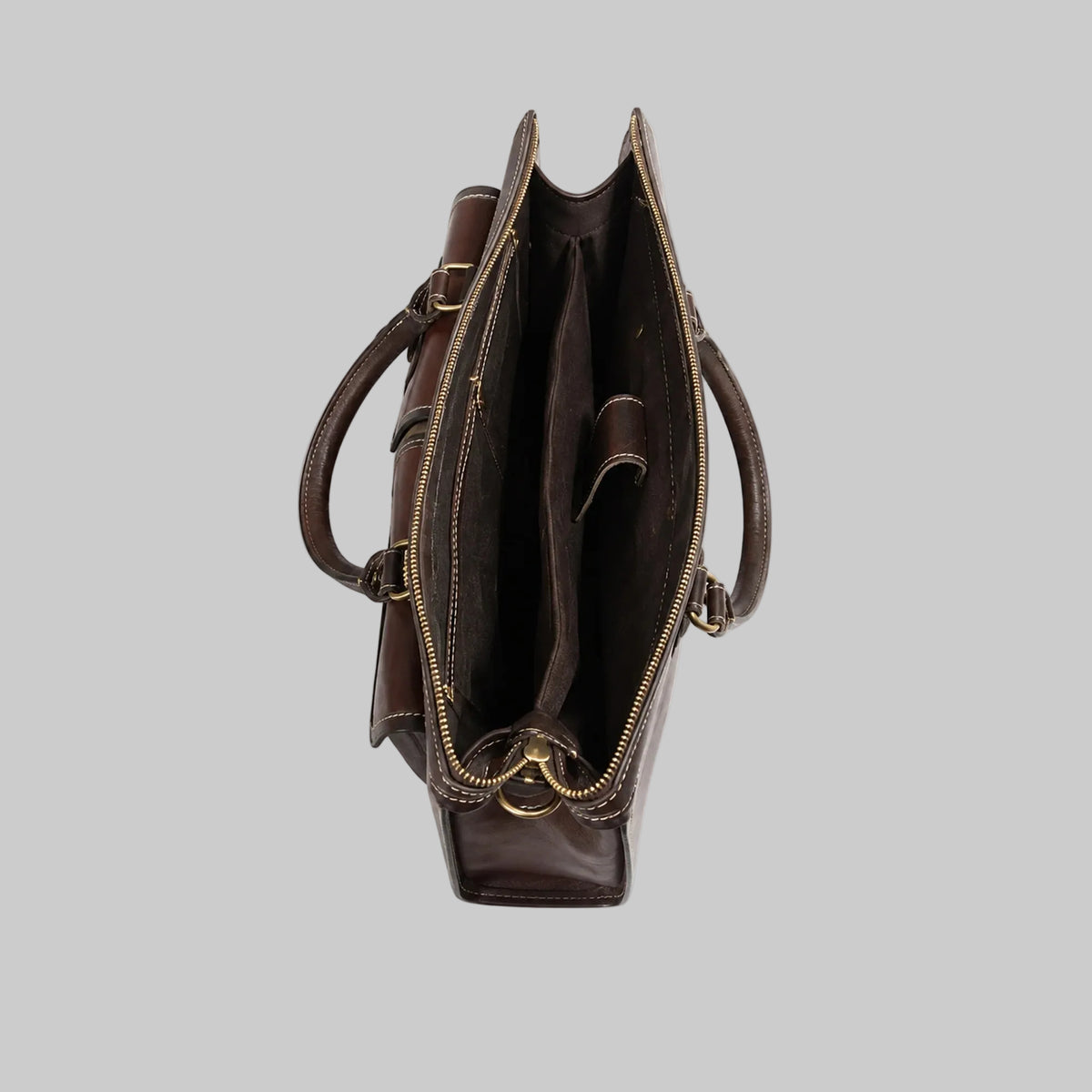 A dark brown leather tote bag shown from a top-down view, featuring dual top handles, a zippered main compartment, and a zippered side pocket with gold-tone metal hardware, set against a plain white background.