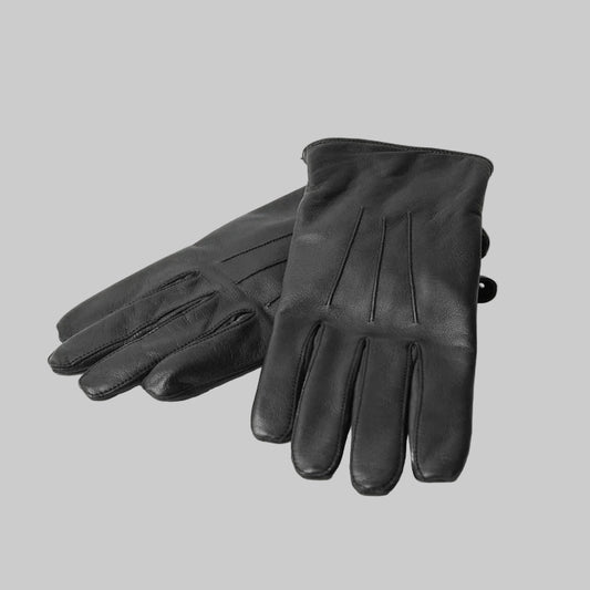 Pair of black leather gloves on a light gray background