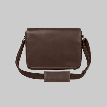 A dark brown leather messenger bag with a matching adjustable shoulder strap and a rectangular leather detail on the front, displayed against a solid white background.