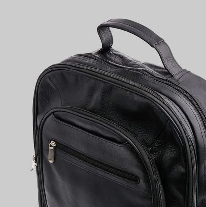 Black backpack with multiple zippers on a white background