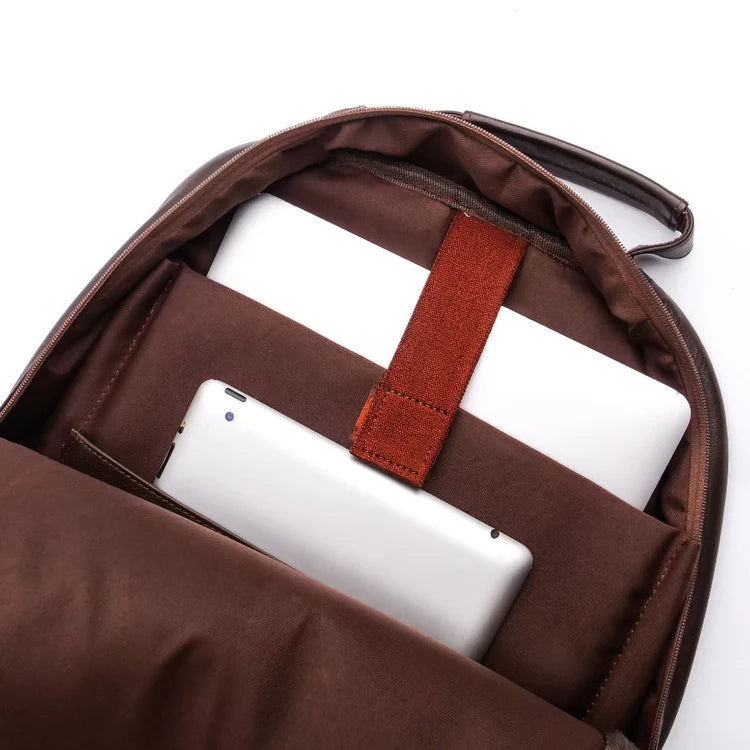 Brown backpack with a white tablet and red strap on a white background