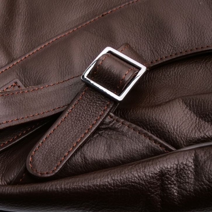 Close-up of a brown leather bag with a buckle detail