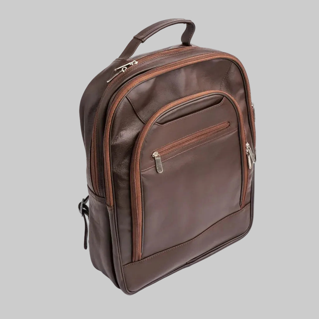 A dark brown leather backpack with matching brown trim and silver zipper pulls, shown on a clean white background.